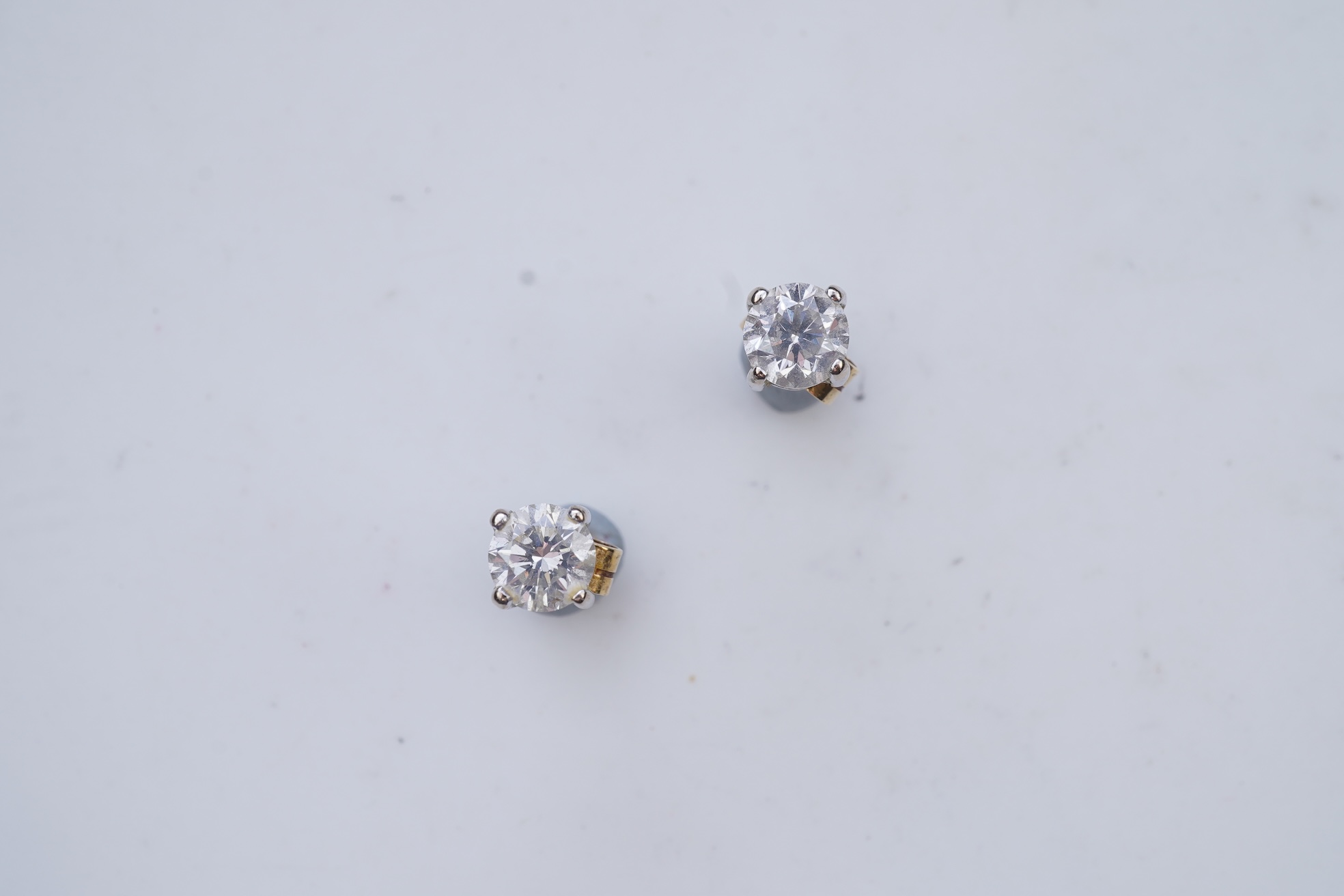 A pair of diamond stud earrings